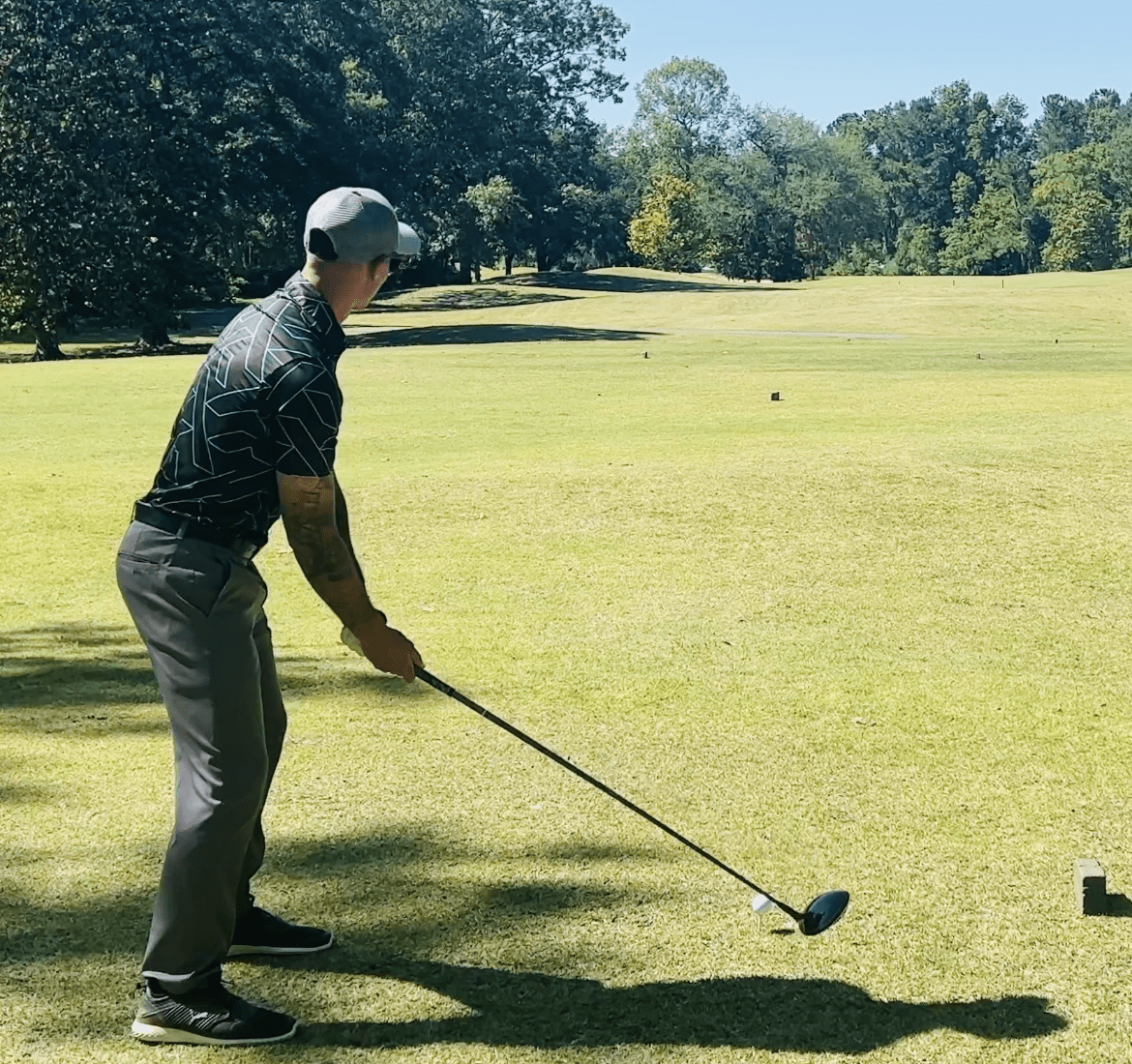Cyan and Black golf shirt with geometric pattern. cheap golf shirts. black golf polo. black golf shirt