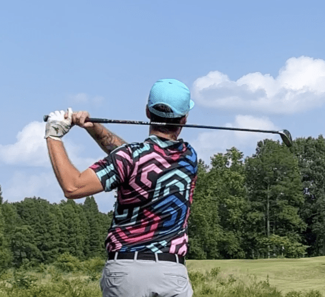 Pink, black and blue golf shirt with hexagonal pattern