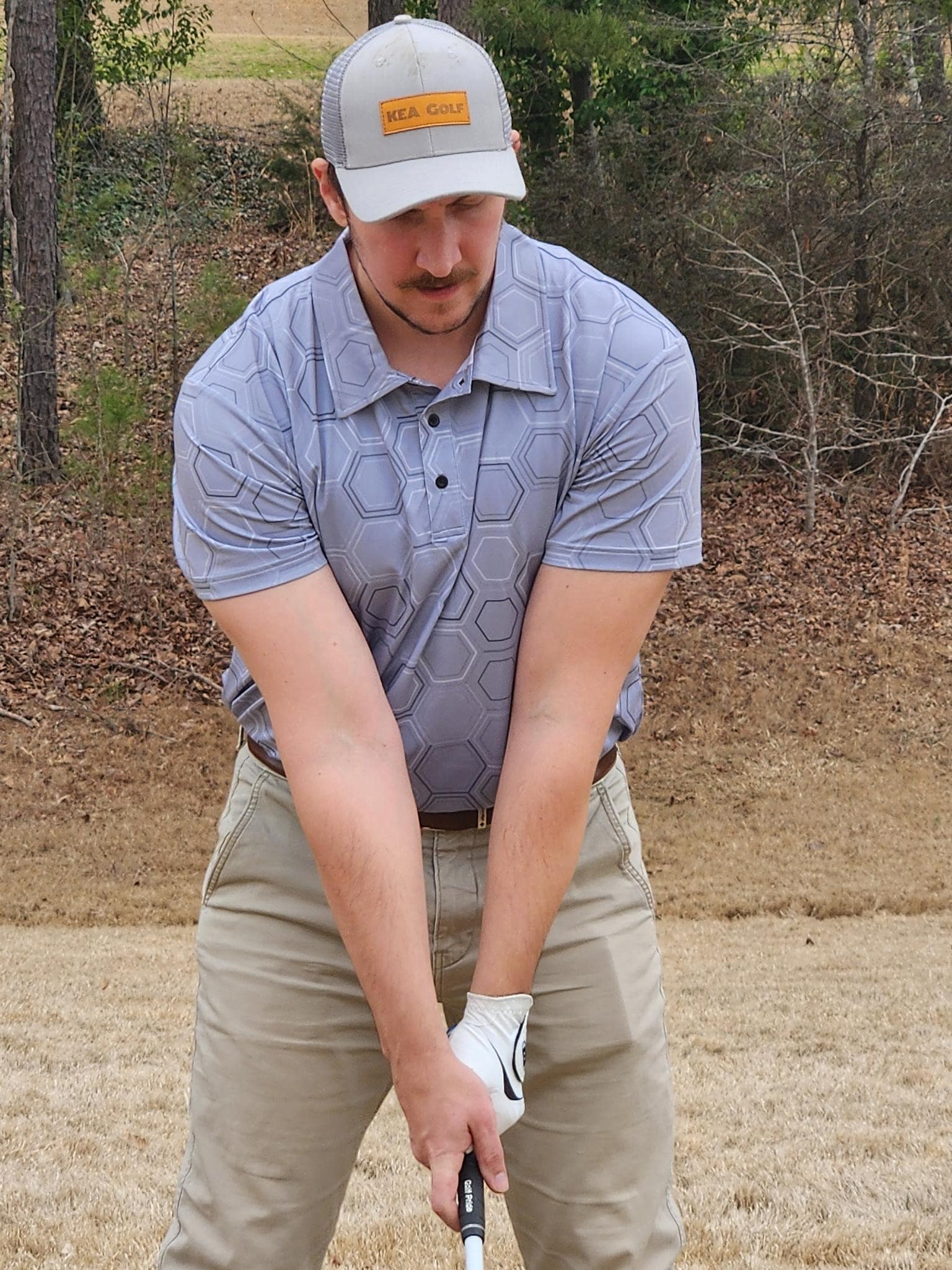 2024 KEA Golf “Graphite Grid” grey with subtle hexagonal pattern Golf polo (front). grey performance golf shirt. 